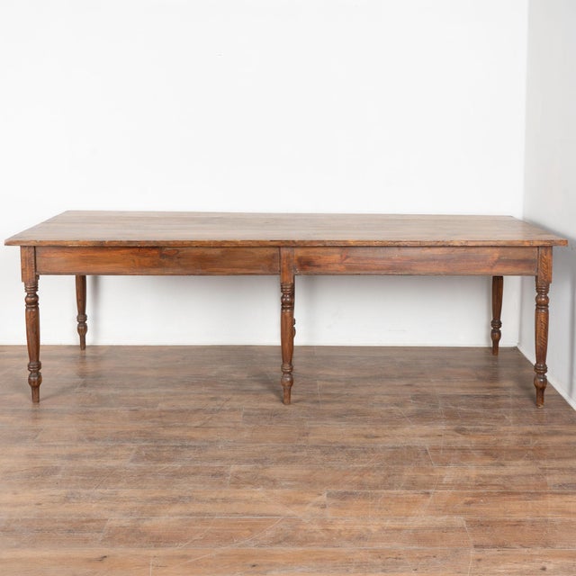 19th century long table from Portugal, crafted in pine and likely originally used as a refectory table. Turned legs and...