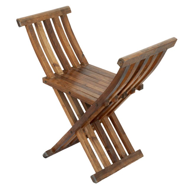 A Vintage Beautifully Hancrafted Folding Chair Imported from Peru. Made of wood.
