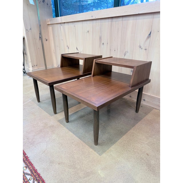 A distinctive pair of vintage Mid-Century Modern step side tables combining clean architectural lines with clever...