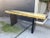 Beautiful Soleil brass console table. Bright gold with black wood legs.