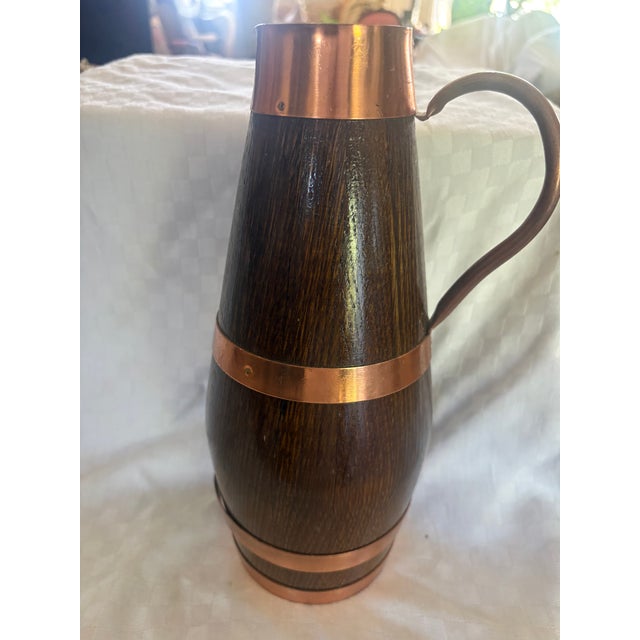 A French staved oak, copper banded cider or wine pitcher. The pitcher was crafted in France in the mid to early 20th C. It...
