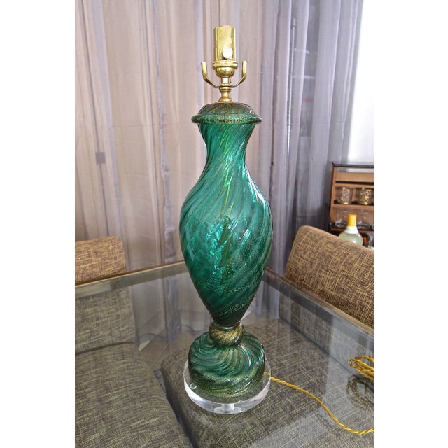 A single tall Italian Murano hand blown emerald green glass with gold inclusions table lamp. Nicely crafted with twisted...