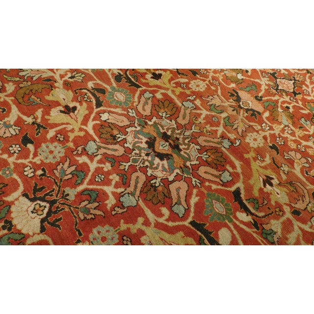 Hand-knotted antique rug. Allover stylized flowers inspired by Ziegler design. Measures 12'x 17'7".