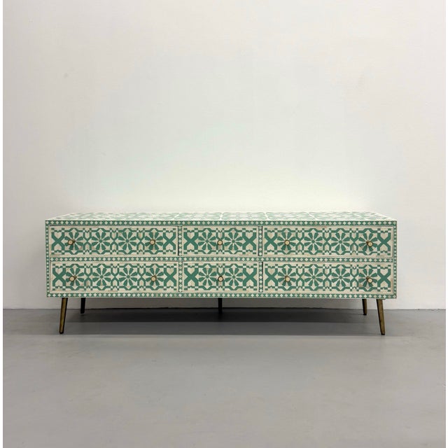 A beautifully handcrafted contemporary bone inlay chest featuring an intricate Moroccan tile pattern in soft teal and...