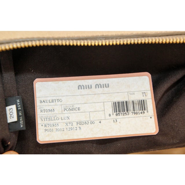 Miu Miu Beige Vitello Lux Leather Bow Handle Bag Satchel Tote. This handle bag from Miu Miu boasts a highly fashionable...