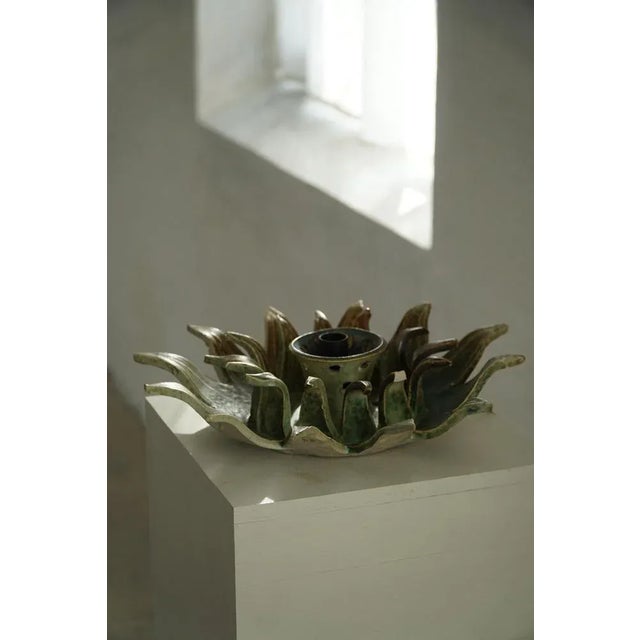 A beautiful mid-20th century ceramic lamp in the form of a stylized sunburst. The hand-crafted design features layered,...