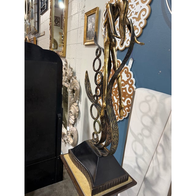 A striking statement piece that effortlessly blends modern sculpture with Art Deco-inspired elegance, this gold tone steel...