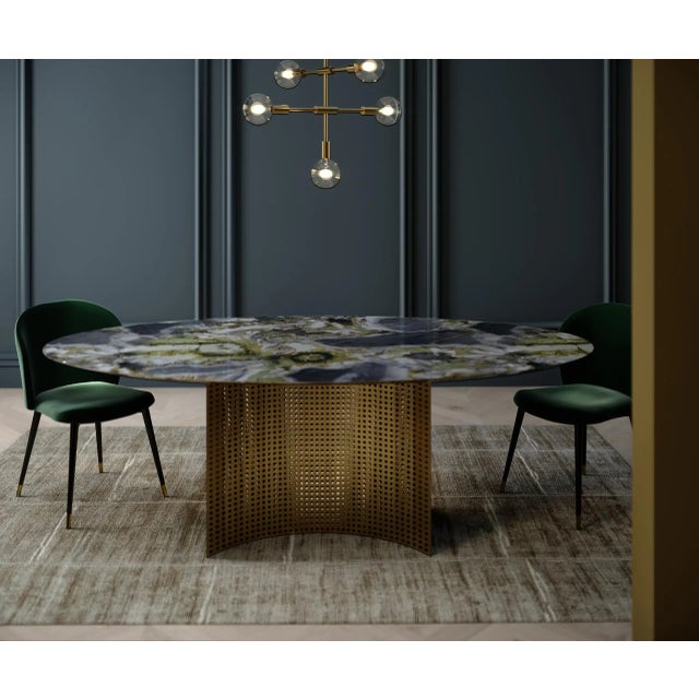 This table has a White Beauty marble top with gold leaf and a brushed blacksand metal base.