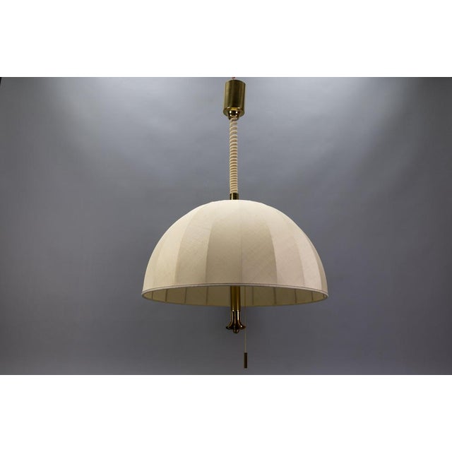 Extra large brass adjustable height five-light pendant lamp with fabric lampshade, Germany, circa 1980. Made in the...