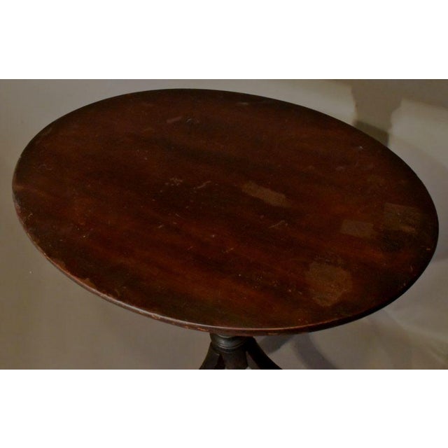 Late Mahogany Hepplewhite transitional stand circa 1810. The graceful oval top tilts above a spiral pedestal over a tall...