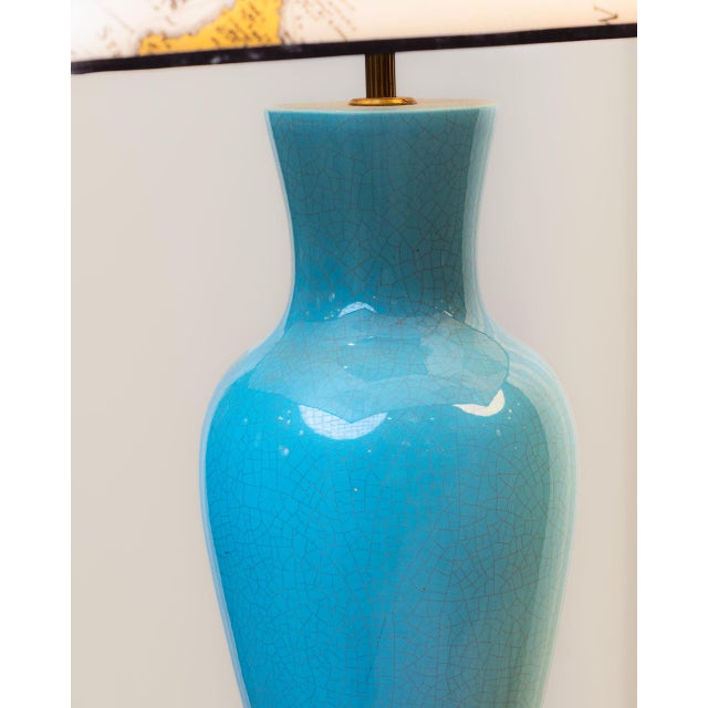 Pair of lamps with glazed ceramic bodies shaped like delicate vases. Gold-plated brass bases. Custom-made pagoda-shaped...