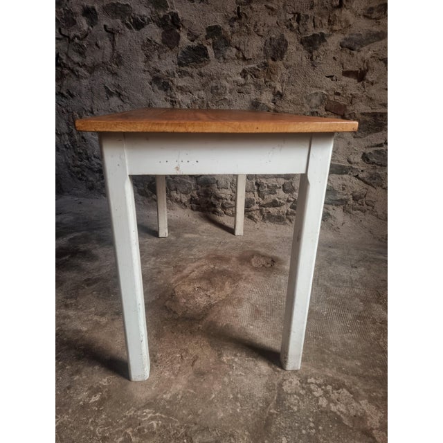 This table was made in France in the 1950s. It features a solid pine tabletop with a warm, natural tone and beech wood...