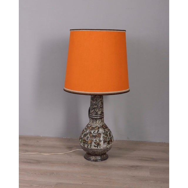 Floor lamp with decorated ceramic structure and large orange fabric lampshade, West German design, 1960s. This piece has...
