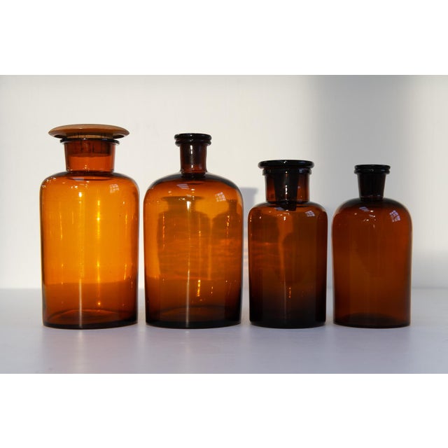 Antique Danish Pharmacy Glass Bottles, 1900s. Set of 4. Set of four hand blown apothecary bottles in brown/golden amber...