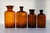 Antique Danish Pharmacy Glass Bottles, 1900s. Set of 4. Set of four hand blown apothecary bottles in brown/golden amber...