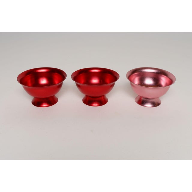 Set of three Mid-Century Modern sherbets or small bowls in anodized aluminum - two red, one pink (ca. 1960s USA). Very...