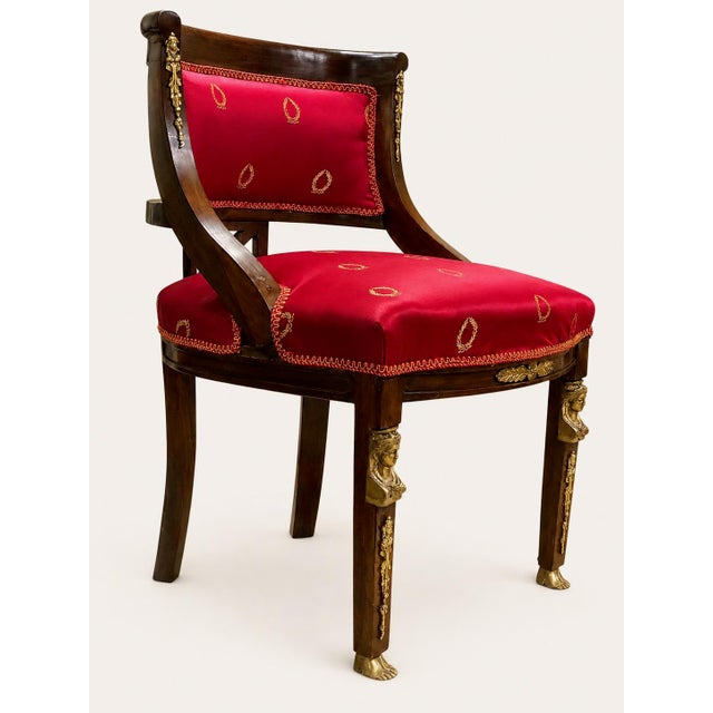 Elegant French Empire-style armchair made during the reign of Napoleon III, circa 1860–1875. Crafted from solid walnut...