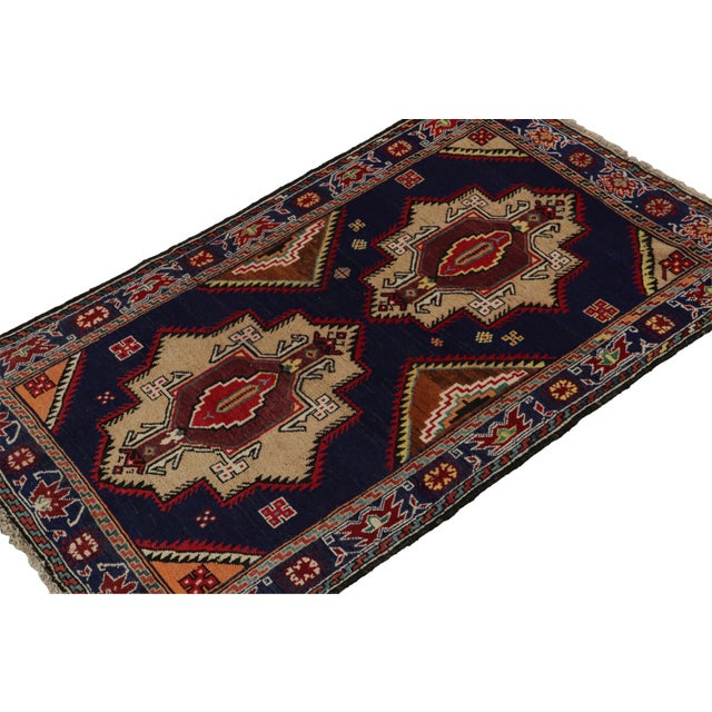 Hand-knotted in wool and goat hair circa 1950-1960, this 4x7 vintage Baluch tribal rug is a new curation from Rug & Kilim....