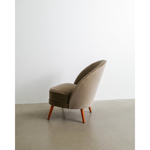 A very rare and iconic swedish asymmetrical mid century modern armchair in newly upholstered brown / green velvet fabric...