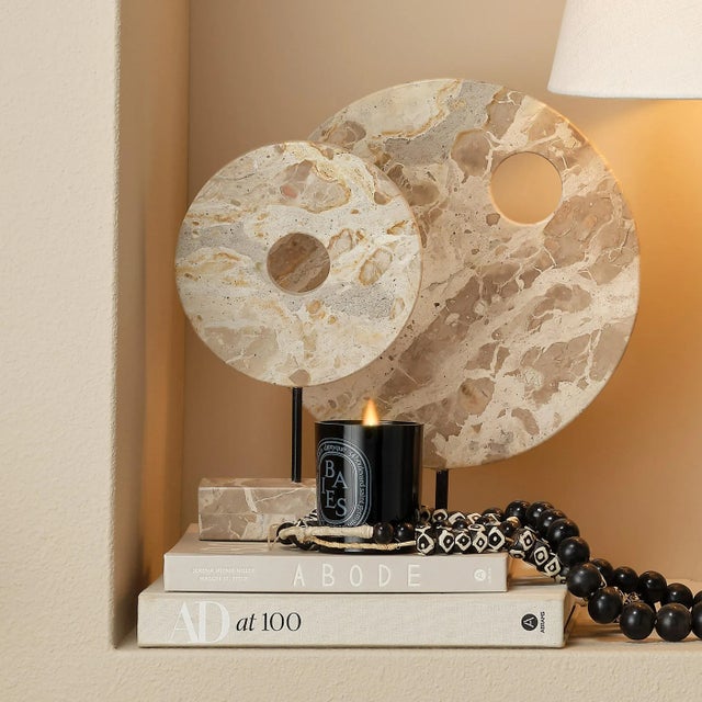 This dramatic sculpture uses cream colored marble to reflect and respect the beauty of celestial objects. The intrinsic...