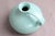 Michael Andersen jug with fluted rim, spout, and handle. Light green/turquoise glaze. The jug is in good condition and...