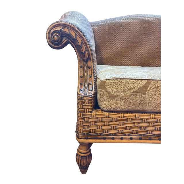 Striking late-20th-century British Colonial-style woven rattan loveseat featuring an exceptionally detailed sculptural...