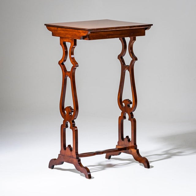 Small Biedermeier side table with a shallow drawer and shaped cut-out legs connected by a stretcher. The table has been...