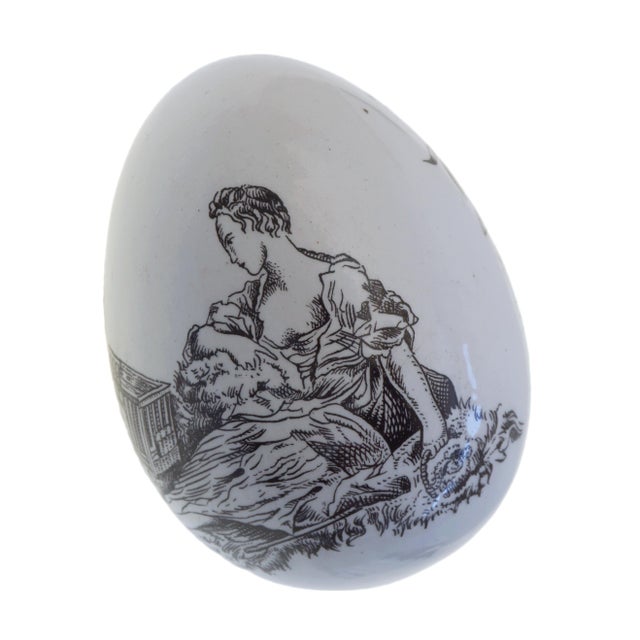 A rare and evocative early English pearlware novelty in the form of a delicate egg, dating to circa 1800–1830. This...