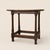 A compact English oak tavern table dating to the late 17th or early 18th century. Its broad single-plank top retains a...