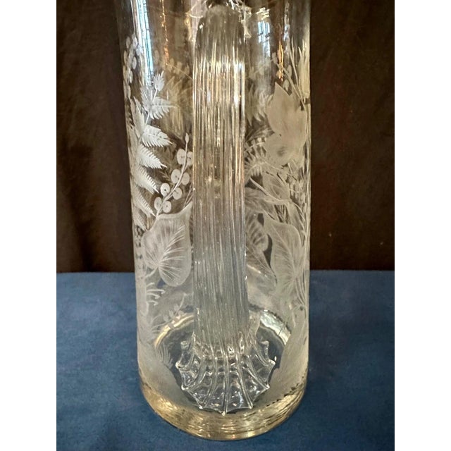 This vintage high quality Continental hand blown glass water pitcher is elaborately designed & decorated with a wild...