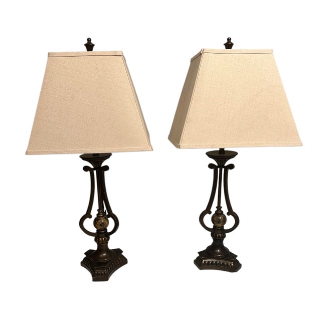 A pair of bronze and marble lamps with a metal and ceramic body. This set of table lamp fits perfectly in mansion or any...