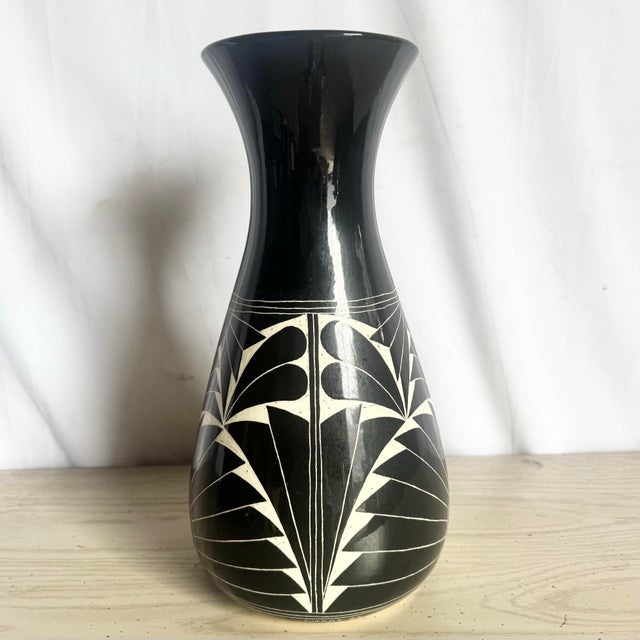 A striking sculptural vase crafted in 1989 by the Curras Brothers, featuring bold black glaze with hand-carved white...