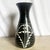A striking sculptural vase crafted in 1989 by the Curras Brothers, featuring bold black glaze with hand-carved white...