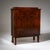 Two-door Art Deco cabinet standing on square legs with a raised platform top. The cabinet is veneered in walnut and hand-...