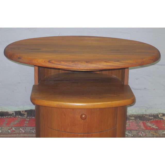 Unusual coffee table in solid teak with an oval top that swivels through 360 deg., with 2 drawers. Silkeborg Denmark label...