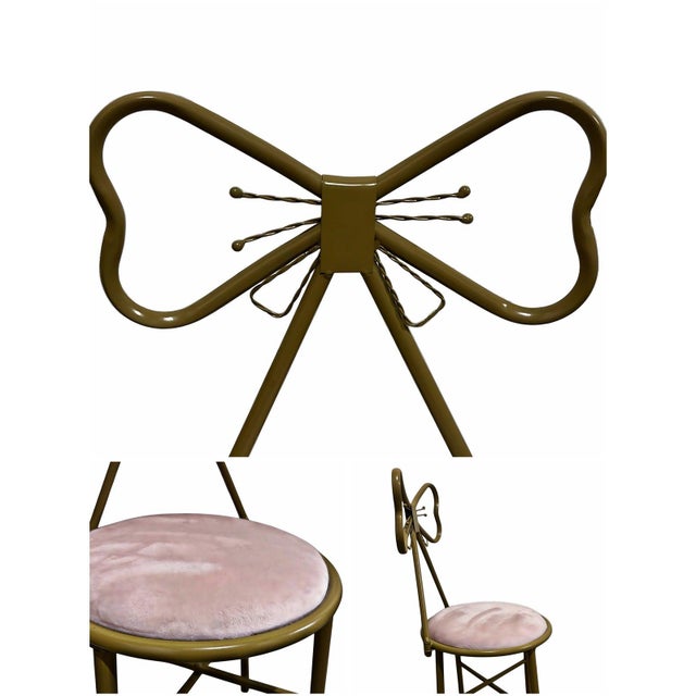 A charming vintage metal chair featuring an ornate bow-tie backrest frame and a round cushioned seat upholstered in soft...