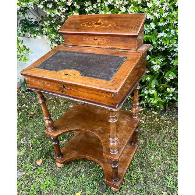 A hand-inlaid Davenport walnut writing desk sourced from a private Roman interior, decorated with delicate satinwood...