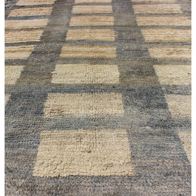 This Tulu carpet features sand colored rectangular shapes with gray outlines. Tulus are woven in the Konya area with a...