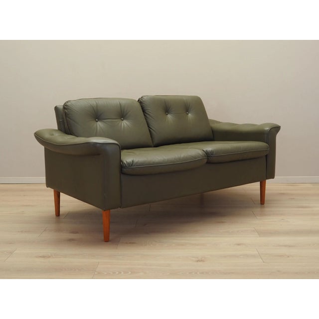 The sofa was made in the 1970s, Danish production. The structure is made of solid wood. The legs of the furniture are made...