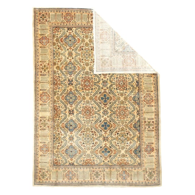 This vintage west Persian high quality small carpet or large scatter, shows a straw-sand field with an offset columnar...
