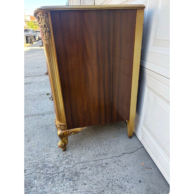 We have a beautiful vintage French Provincial bombe dresser for sale featuring walnut burl veneer, intricate floral...