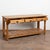 20th-century English pine console table featuring three drawers with large wooden pulls, scalloped skirt, turned legs, and...