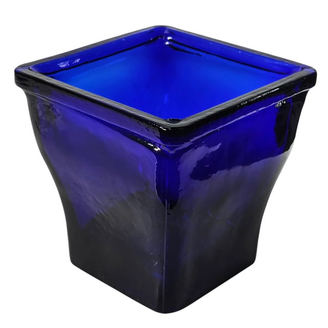 This is a stunning cobalt blue glass vase made of thick recycled glass. The the deep blue glass has optic properties that...