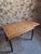 This vintage table originates from the Vichy region and dates from around 1930. It features a pine tabletop combined with...