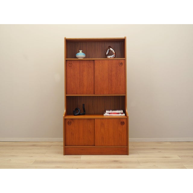 The bookcase was made in the 1960s, Danish production. The structure is covered with teak veneer. The piece is placed on a...