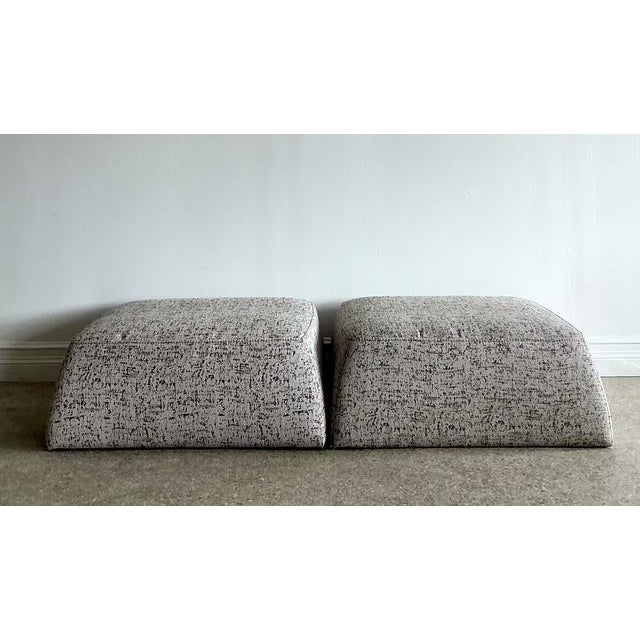 This striking pair of low-profile ottomans by the esteemed Italian manufacturer Natuzzi is a masterclass in contemporary...