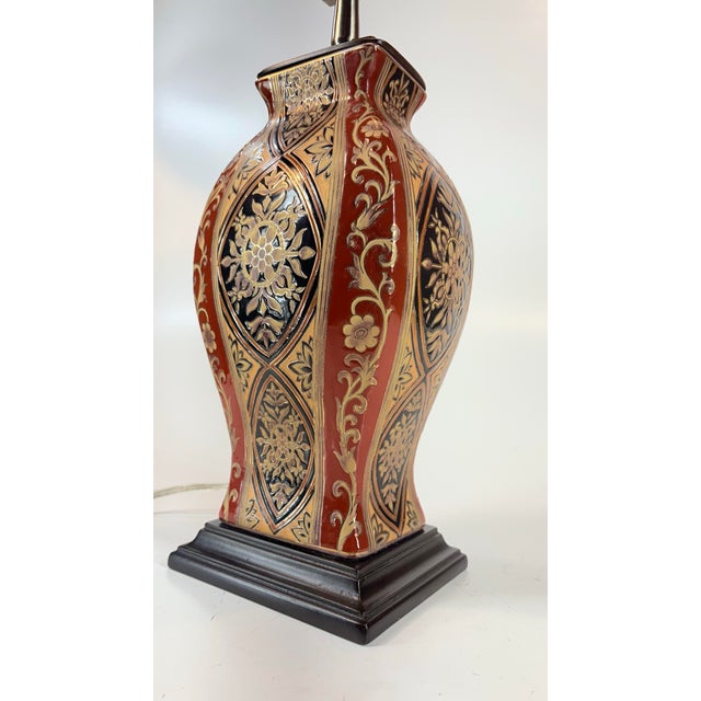 This Italian Rococo Style Glazed Porcelain Gilded Vase Form Table Lamp is a stylish and unique lighting piece that...