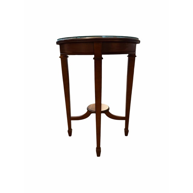 Crafted by the renowned Hekman Furniture Co. of Grand Rapids, Michigan, this classic Federal style round occasional table...