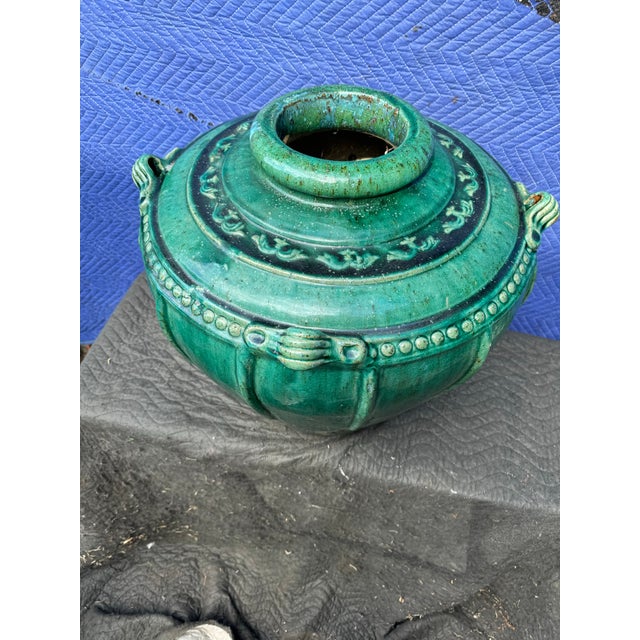 Large heavy vintage green planter . 21” tall and 25” wide , one handle is broken off . Piece has a hole at the bottom and...