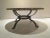 This Brutalist style table with a marble top featuring a rough edge was produced circa 1970. It has a handmade metal base.